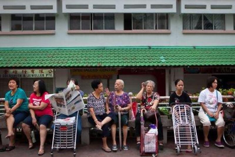 Women at a public housing estate in Singapore. They are being told to be intimate with their husbands two to three times a week to increase their chances of conception during ovulation.