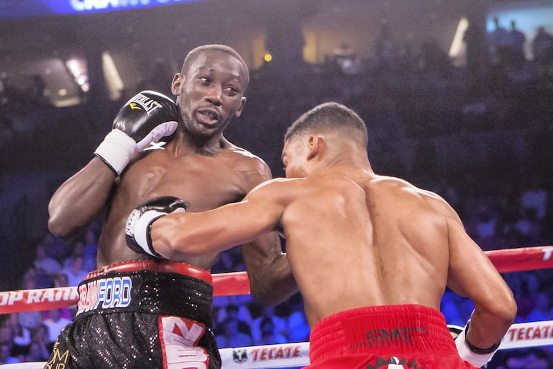Terence Crawford (left) connects with a left uppercut while Yuriorkis Gamboa (right) connects with a body blow during the WBO world lightweight championship boxing bout June 28, 2014 in Omaha, Neb., Saturday. (AP Photo/John Peterson)