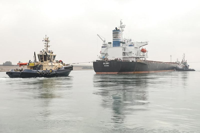 A tugboat pulls the Marshall Islands-flagged bulk carrier M/V Glory in the Suez Canal near al-Qantarah between Port Said and Ismailia. AFP
