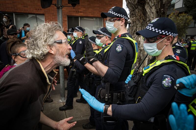 Anti-lockdown protesters clash with Victoria Police in the suburb of Richmond. Photo: Getty