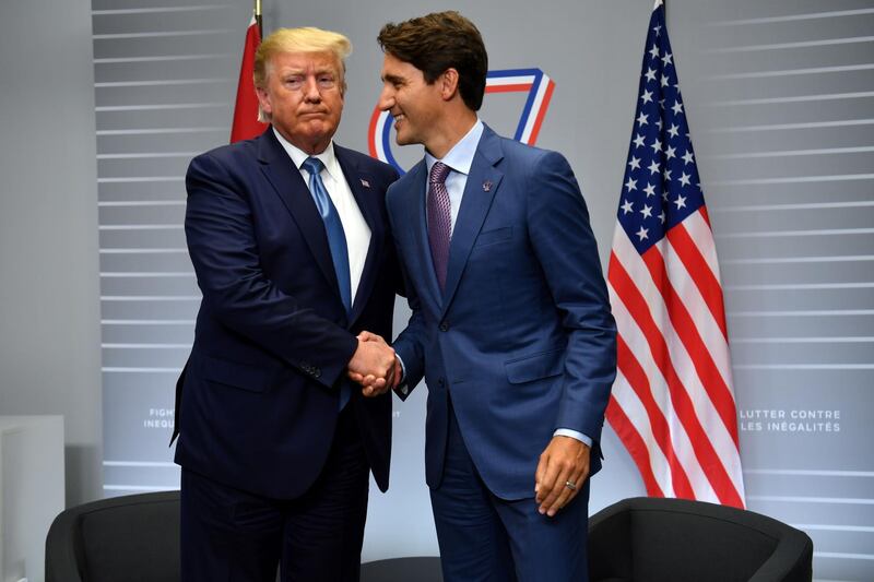 US President Donald Trump and Canada's Prime Minister Justin Trudeau shake hands during a bilateral meeting at the Bellevue centre in Biarritz, south-west France.  AFP