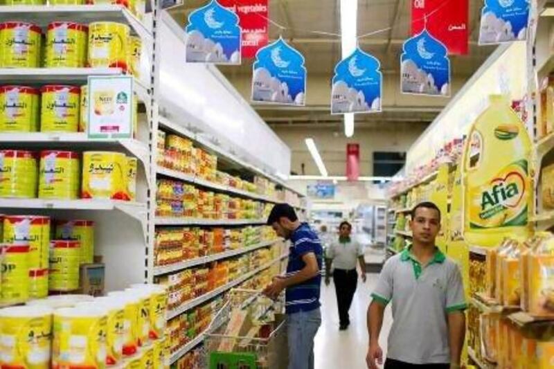 A shopper browses grocery items at Emirates Cooperative Society, where a sign advertises Ramadan pricing, in Al Twar 3 in Dubai.