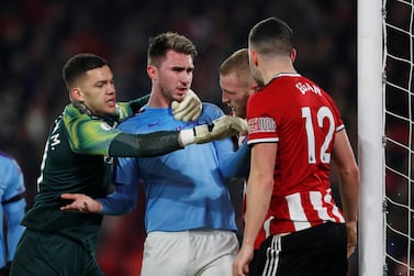 Manchester City's Aymeric Laporte and Sheffield United's John Egan clash. Reuters