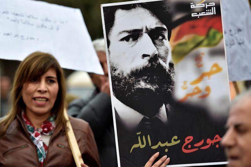 A Lebanese activist carries a picture depicting Lebanese prisoner George Abdallah, who is detained in France, during a protest calling the French authorities for his release outside of the French Embassy in Beirut, Lebanon. Abdullah has been in prison for 35 years, after he was arrested in Lyon in October 1984 and condemned three years later to life in prison for alleged involvement in the killing of an Israeli diplomat and an American military attache in Paris in 1982.  EPA