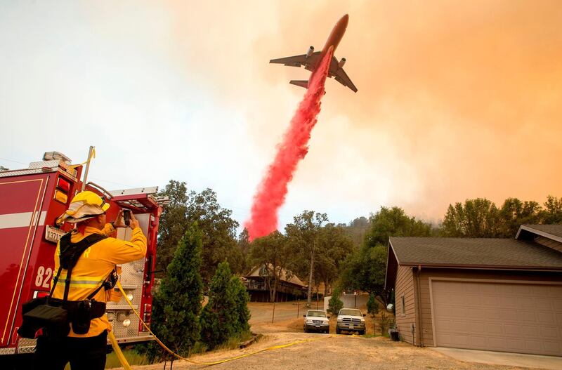 An air tanker drops fire retardant on flames during wildfires in California. Josh Edelson / AFP Photo  / July 19, 2017
