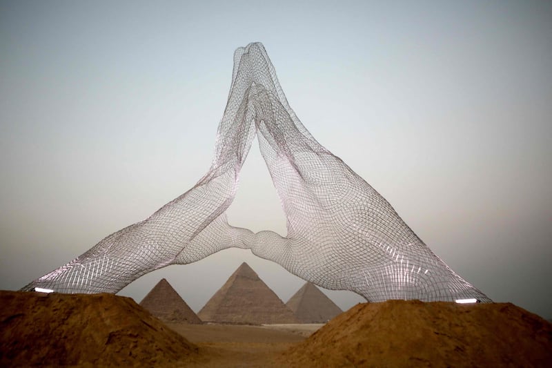 An installation by Italian artist Lorenzo Quinn, entitled Together, faces the pyramids at the ancient Giza necropolis . Photo: Patrick Baz/ Art Degypte  