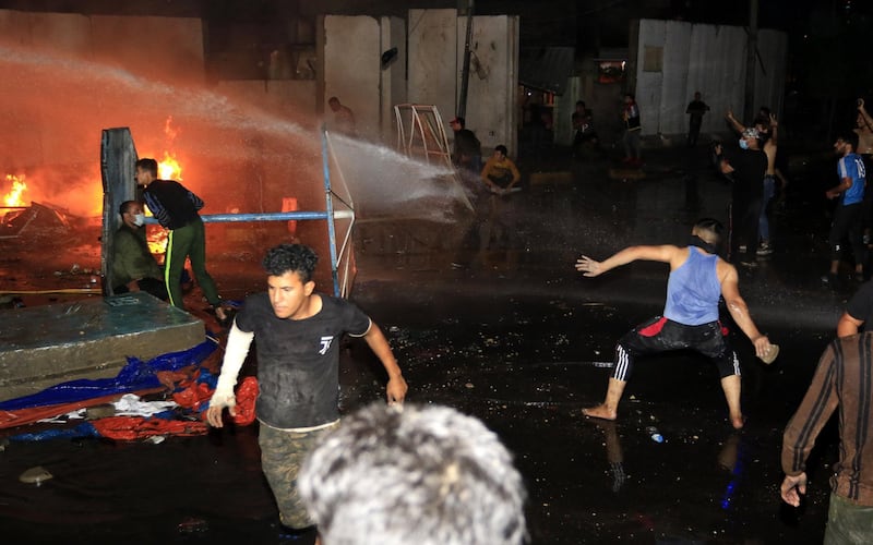 epa07949842 Iraqi protesters clash with riot police forces near the local government headquarters following a demonstration in Karbala, southern Iraq, 25 October 2019.Thousands of protesters in Baghdad and southern Iraqi cities staged new protests against the Iraqi government corruption and poor government services. At least 20 protesters were killed and dozens others were wounded during clashes with riot police forces in Baghdad and Nasriyah city southern Iraq.  EPA/FURQAN AL-AARAJI