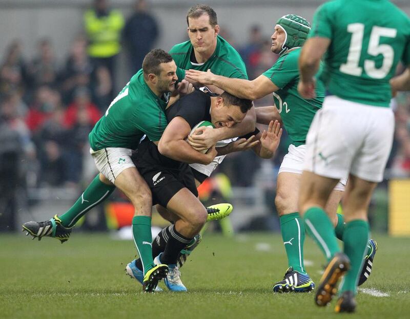 New Zealand flanker Steve Luatua, center, is tackled by Ireland's David Kearney and Peter O'Mahony during their Test match in Dublin on Sunday. Peter Muhly / AFP