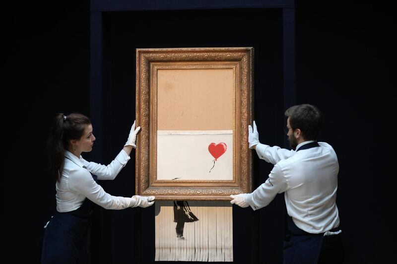 LONDON, ENGLAND - OCTOBER 12: Sothebyâ€™s unveils Banksyâ€™s newly-titled â€˜Love is in the Binâ€™ at Sotheby's on October 12, 2018 in London, England. Originally titled â€˜Girl with Balloonâ€™, the canvas passed through a hidden shredder seconds after the hammer fell at Sothebyâ€™s London Contemporary Art Evening Sale on October 5, 2018, making it the first artwork in history to have been created live during an auction. (Photo by Tristan Fewings/Getty Images for Sotheby's)