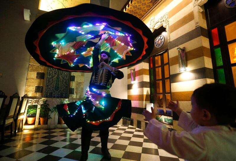 Muayad Al Kharrat dances in a costume decorated with LEDs at a restaurant in the Shahgur district.  AFP