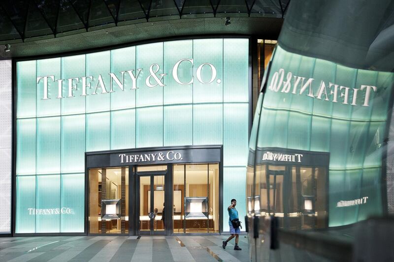 A pedestrian using a mobile phone walks past a Tiffany & Co. store on Orchard Road in Singapore, on Wednesday, June 8, 2016. Singapore is scheduled to release April retail sales figures on June 15 as vacancies in the city's main Orchard Road area have risen to a five-year high and across the island, they've soared to the highest since 2009. Photographer: Ore Huiying/Bloomberg