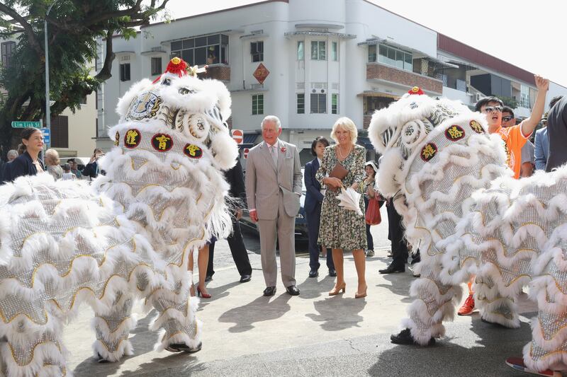 Prince Charles and Camilla, Duchess of Cornwall are greeted by lion dancers upon arrival at Tiong Bahru Market in Singapore. Chris Jackson / Getty Images