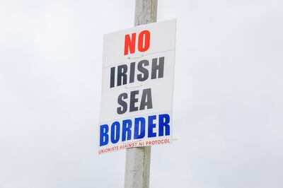 A sign on a lamppost reading "No Irish Sea Border" in the port town of Larne, U.K., on Wednesday, June 9, 2021. Officials from Britain and the European Union are meeting on Wednesday to try and defuse a row over Northern Ireland that threatens to spill over into this week’s Group of Seven summit. Photographer: Paul Faith/Bloomberg