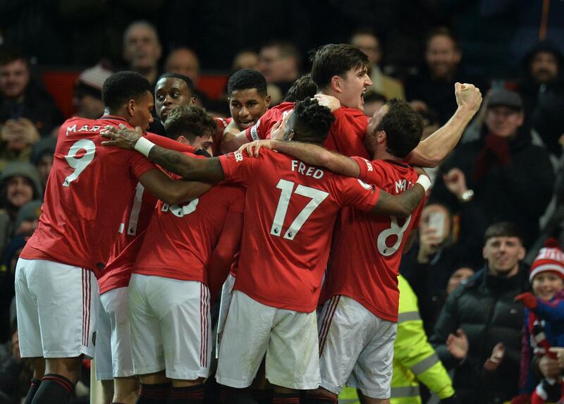 Manchester United's Swedish defender Victor Lindelof (C) celebrates with teammates after scoring an equaliser to make it 2-2 against Aston Villa. AFP