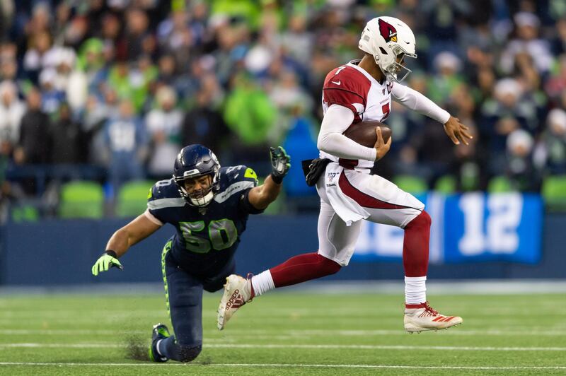 Arizona Cardinals quarterback Brett Hundley evades a tackle by Seattle Seahawks outside linebacker K.J. Wright (50) during the second half at CenturyLink Field. Arizona won 27-13. USA TODAY Sports