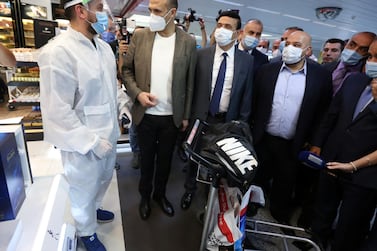 Lebanon's Health Minister Hamad Hassan, second left, speaks to a passenger who arrived at Beirut international airport when it reopened on July 1, 2020. Reuters