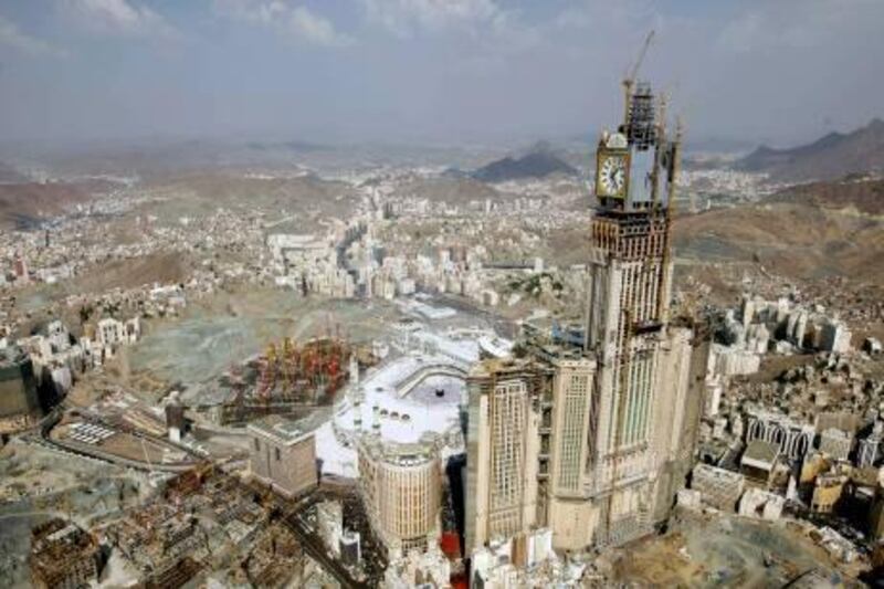 This aerial image made from a helicopter taken on Wednesday, Nov. 17, 2010, shows Muslim pilgrims moving around the Kaaba, the black cube seen at center, inside the Grand Mosque, during the annual Hajj in Mecca, Saudi Arabia. The skyscrapers, sporting towering glass facades and luxury shopping malls with international brands, have sprouted up in recent years around the esplanade in front of the sprawling, multi-level Haram Mosque. The mosque surrounds the Kaaba, the cube-shaped shrine that Muslims around the world face during prayers and pilgrims circle seven times during the hajj rites. (AP Photo/Hassan Ammar) *** Local Caption ***  HAS115_Saudi-Hajj.jpg