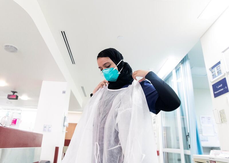 ABU DHABI, UNITED ARAB EMIRATES. MAY 2020.
Medical resident at Sheikh Khalifa Medical City, Khuloud Al Haj Banimatar, puts on the PPE.
(Photo: Reem Mohammed/The National)

Reporter:
Section: