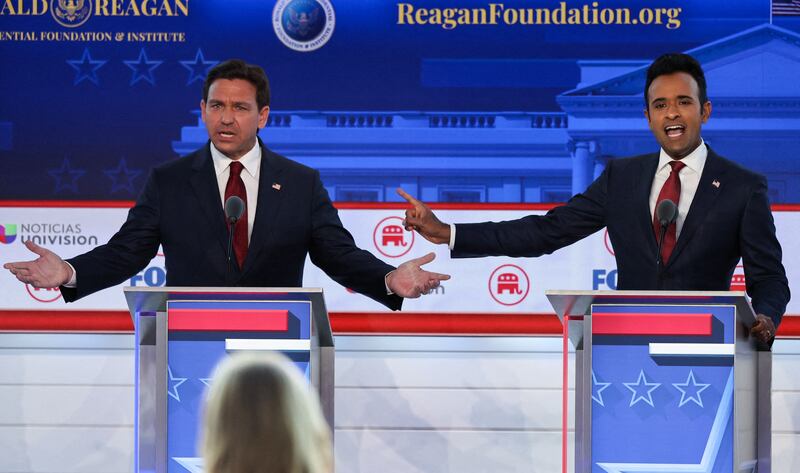 From left, Florida Governor Ron DeSantis and former biotech executive Vivek Ramaswamy talk over each other at the debate. Reuters