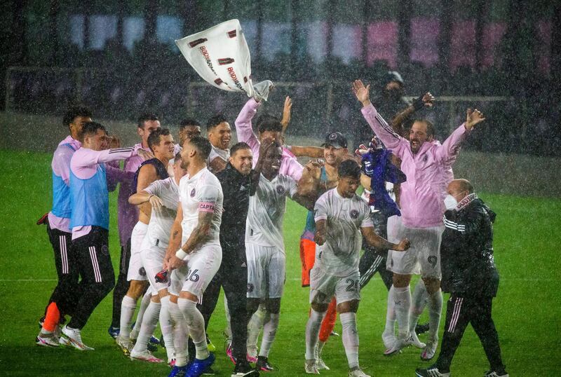 Inter Miami coach Diego Alonso celebrates in the rain with his team after their win over Cincinnati. AP