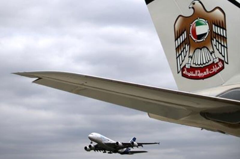 August 9, 2010/ Toulouse France / Airbus's test A380 aircraft takes off adjacent to a new Etihad Airbus A330-200 Freighter which Etihad will use for its cargo business in Toulouse France August 9, 2010.  (Sammy Dallal / The National)

