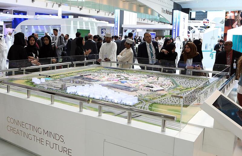 Visitors look at the Expo 2020 Dubai Project during the WFES summit in Abu Dhabi. Satish Kumar / The National