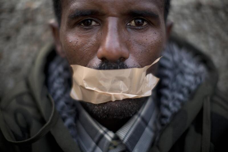 An African migrant covers his mouth with tape during a protest in Tel Aviv last year. Many migrants are from Eritrea and Ethiopia and are often given just 30 days to leave the country. Oded Balilty / AP Photo