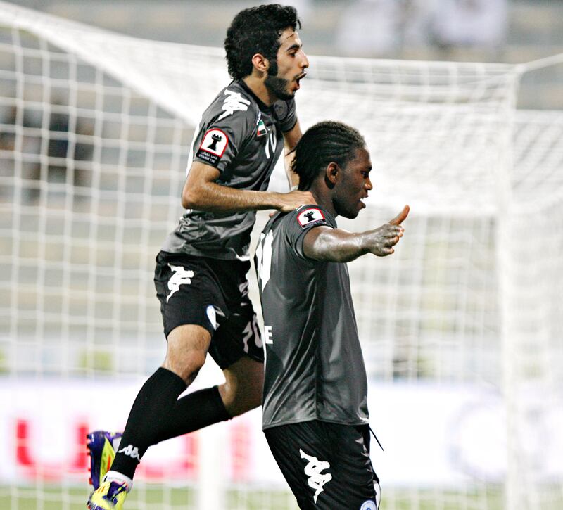 DUBAI, UNITED ARAB EMIRATES - October 10, 2012- An unidentified AL Dhafra player jumps on the back of Makhete Diop after Diop scored his third goal during second half football action against Al Wasl in Zabell Stadium in Dubai City, Dubai October 10, 2012. (Photo by Jeff Topping/The National) PLAYER NOT LISTED ON THE ROSTER. WILL GET NAME AFTER MATCH.