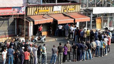 People queue outside a bakery in the southern Lebanese city of Sidon. The country has been gripped by an economic crisis since 2019. AFP