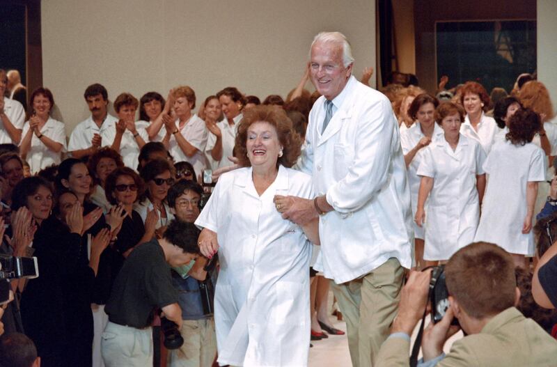 In this file photo taken on July 11, 1995 French fashion designer Hubert de Givenchy, flanked by his secretary Jeannette (L), acknowledges applause at the end of his Fall/Winter 1995/1996 high-fashion collection shown in Paris. AFP