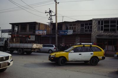 January 15th, 2019 - Kabul, Kabul, Afghanistan:  Cars and Taxis drive past damaged shops and homes in the Qabil Bai district of Kabul. The shops were damaged by an explosion that targetted a foreigner compound.
The attack on the Green Village, a compound in Kabul that houses foreign workers and NGO's, initially killed 9 and wounded over 120 Afghans who lived in the vicinity. There was also extensive property damage to the surrounding homes and shops. 

Ivan Flores/The National