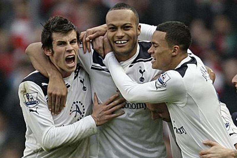 Younes Kaboul, centre, celebrates the match-winning goal with his Tottenham teammates Gareth Bale, left, and Jermaine Jenas.