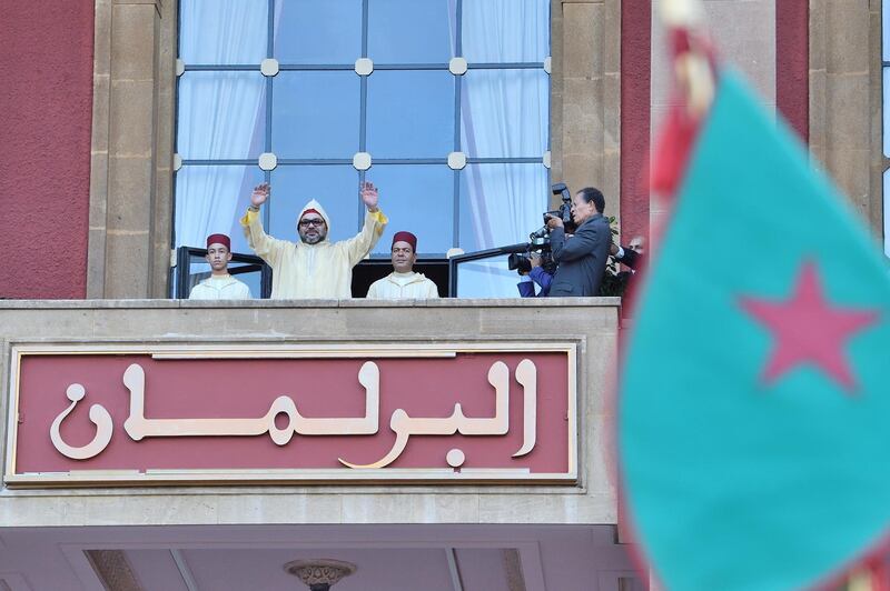 In this photo provided by the Moroccan Palace, Moroccan King Mohammed VI flanked by his brother Prince Moulay Rachid right and the crown prince Moulay Hassan left waves to the crowd after he delivers a speech during the opening session in the Morocco Parliament in Rabat, on Friday, Oct. 13, 2017. King Mohamed VI outlined policies for the new parliamentary session Friday, saying more needs to be done to address poverty and help youth after protests in a northern town. He also announced the creation of a new ministry for African affairs. (Moroccan Royal Palace via AP)