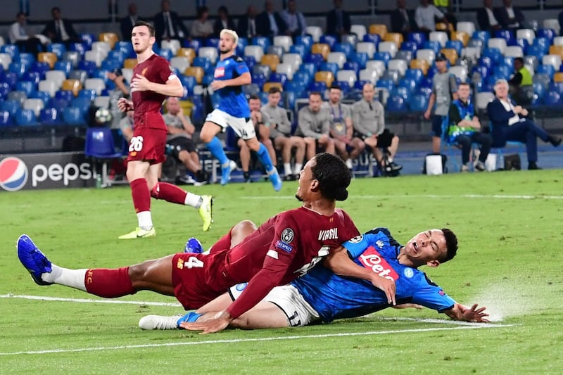 Napoli's Hirving Lozano and Liverpool's Virgil van Dijk in action. EPA