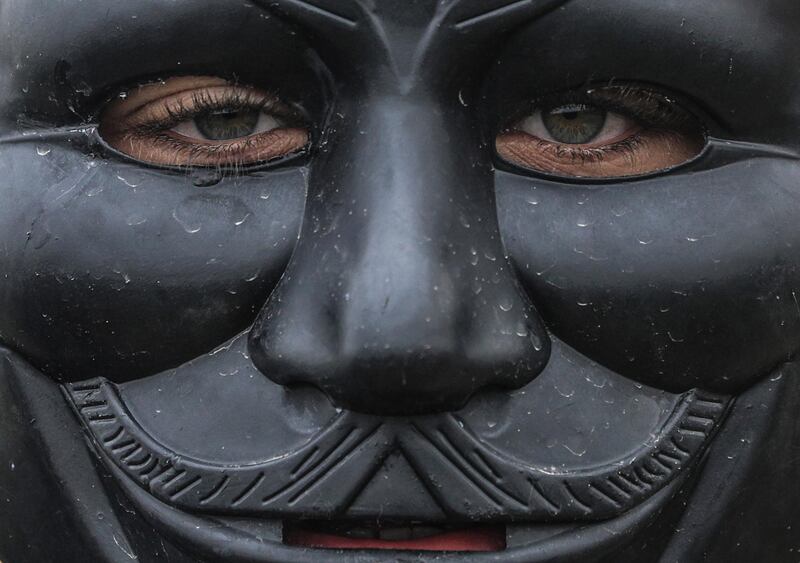 A Palestinian protester wears a Guy Fawkes mask during the clashes near the border between Israel and Gaza Strip. EPA
