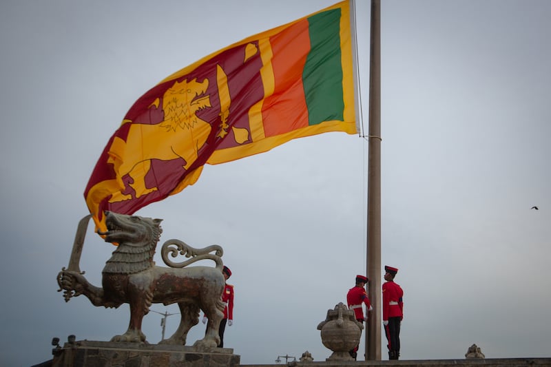 Soldiers lower the national flag at Galle Face Green in Colombo. Getty