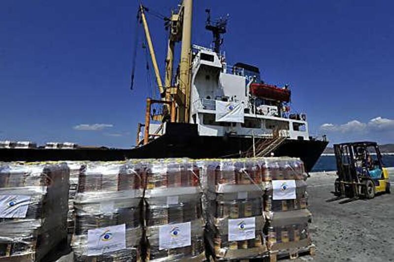 Workers load aid supplies on to the cargo ship Amalthea at the Lavrio port, about 60 kilometres southeast of Athens, Greece.