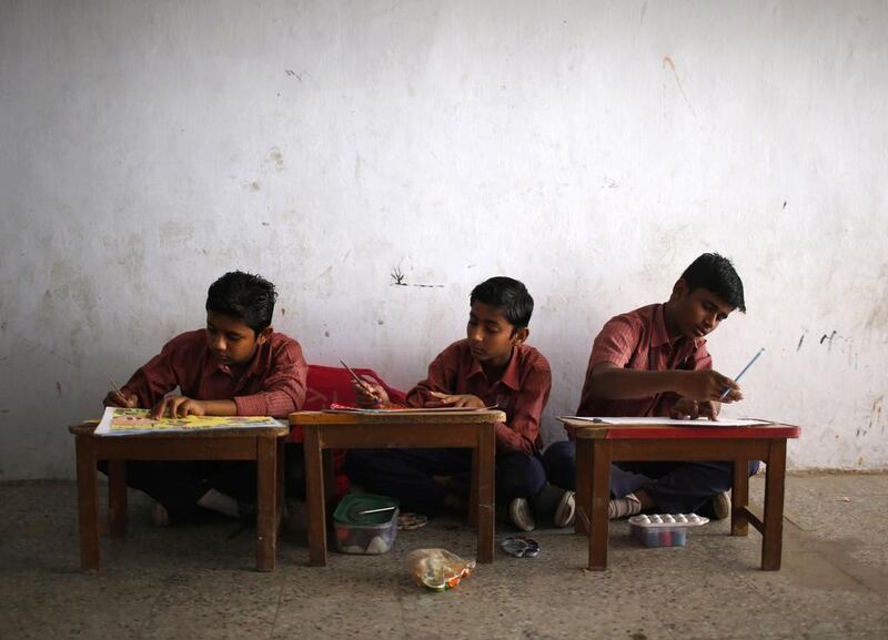 Muslim boys attend a painting class at a school.