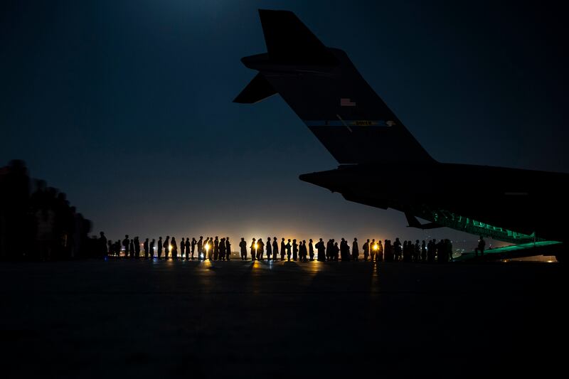 People prepare to board a US Air Force aircraft at Hamid Karzai International Airport in Kabul, Afghanistan. Photo: US Department of Defence