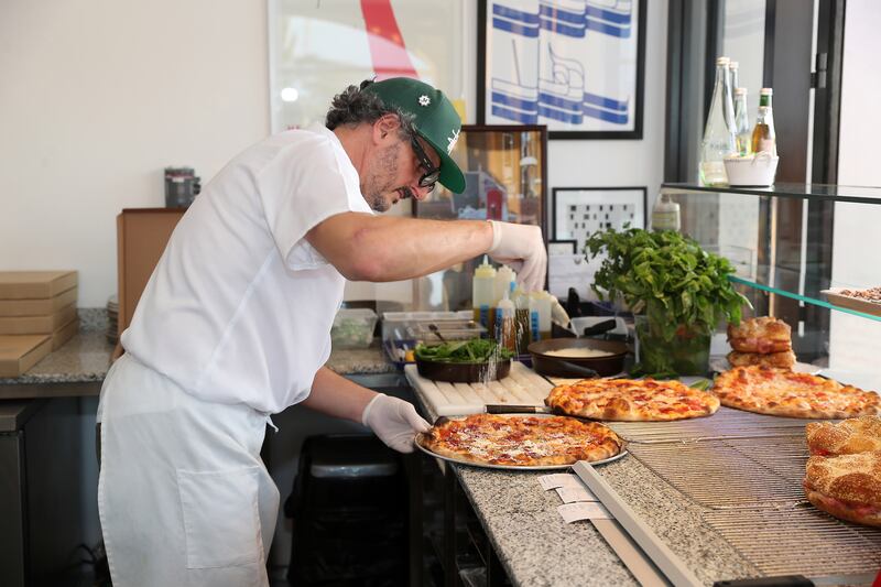 Raj Dagstani makes fresh pizza at Marmellata in Mina Zayed Port, Abu Dhabi. All photos: Pawan Singh / The National
