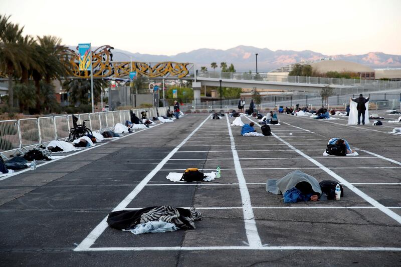 Homeless people sleep in a temporary parking lot shelter at Cashman Center, with spaces marked for social distancing to help slow the spread of coronavirus disease (COVID-19) in Las Vegas, Nevada, U.S. REUTERS