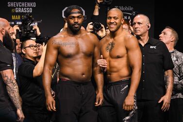 US mixed martial arts fighter Jon Jones (L) and French mixed martial arts fighter Ciryl Gane (R) face off during the ceremonial weigh-in ahead of their UFC 285 heavyweight title bout at the MGM Garden Arena, in Las Vegas, Nevada on March 3, 2023.  - Jones will fight Ciryl Gane of France for the title on March 4.  (Photo by Patrick T.  Fallon  /  AFP)
