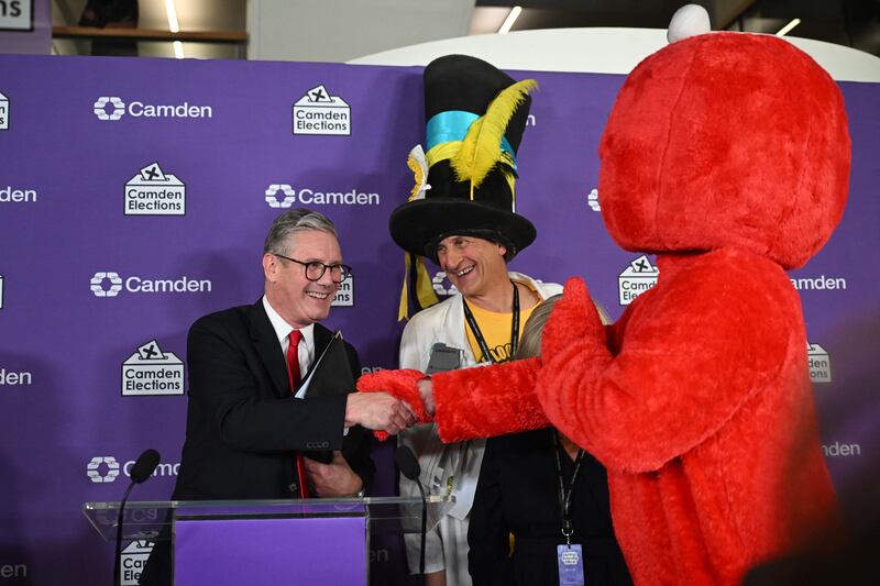 Mr Starmer is congratulated by fellow candidates Bobby 'Elmo' Smith and Nick 'The Flying Brick' Delves after winning his seat for Holborn and St Pancras, at the Camden Council count centre in London. AFP