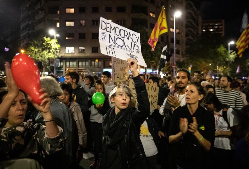Catalan pro-independence protesters demonstrate outside the Department of the Interior, at night in downtown Barcelona, Spain. AP Photo