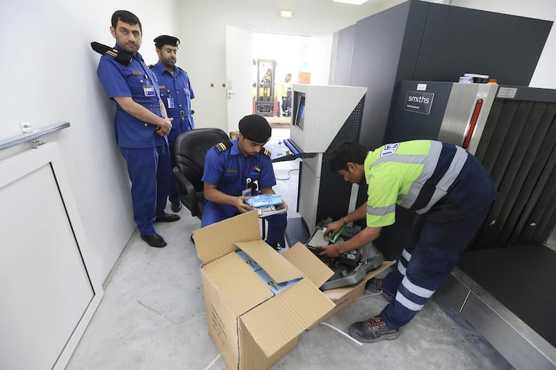 Dubai Customs inspectors manually sort through a shipment after x-raying it to look for contraband or inconsistencies in Jebel Ali Port in Dubai. Sarah Dea / The National