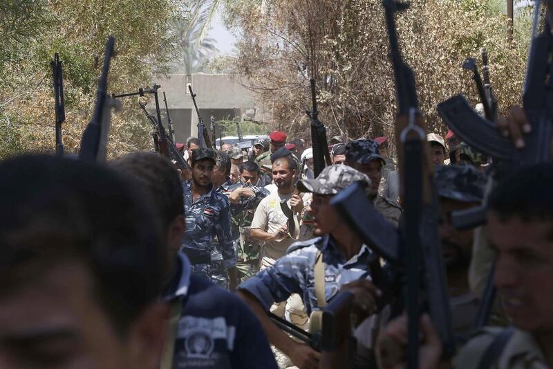 Iraqi soldiers from the Abbas Unit gather in Jurf Al Sakhr, 60 kilometres southwest of Baghdad on August 10, after they reportedly pushed back Islamist militants from the area. AFP

