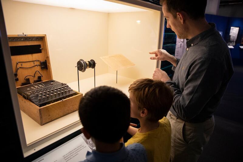 Visitors examine an enigma machine. Courtesy Science Museum Group