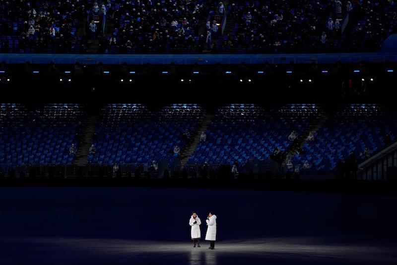 Hosts address the crowd during the pre-show ahead of the opening ceremony of the 2022 Winter Olympics. AP Photo