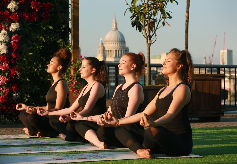 Women taking part in a yoga class. Company managers must make mental health a strategic priority, according to the McKinsey Health Institute. PA