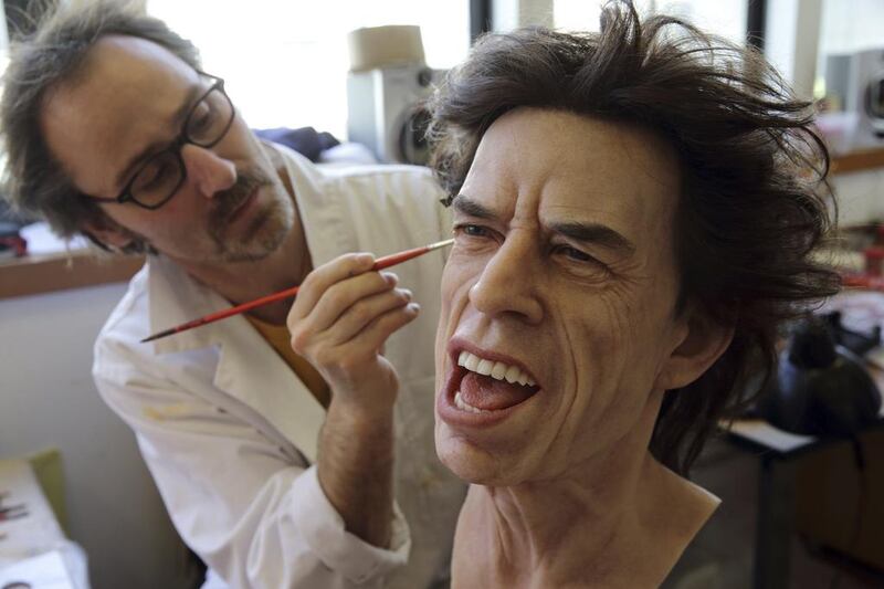 Painter Franck Bruneau works on the head of Rolling Stones lead singer Mick Jagger at their workshop in Paris on April 9, 2014. Philippe Wojazer / Reuters